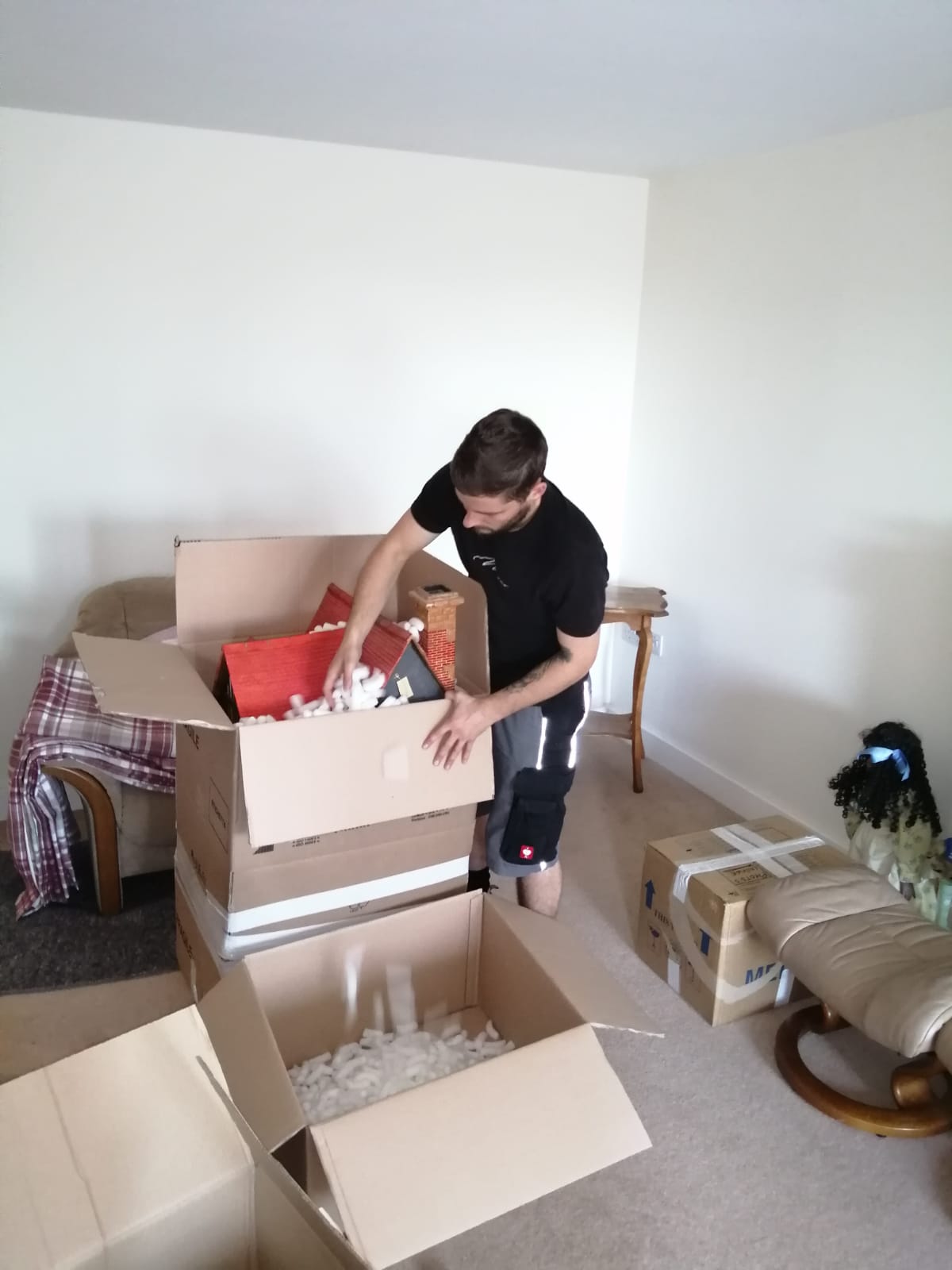 a premier movers worker packing up a house for a house clearance